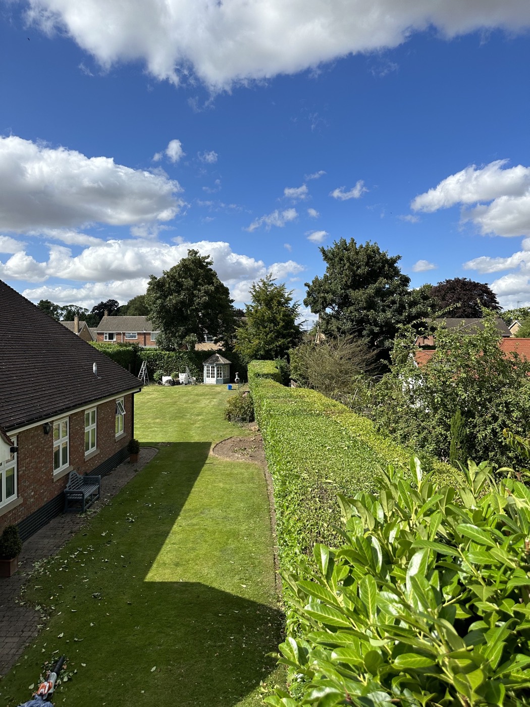 A neatly cut boundary hedge and freshly mown lawn maintained by MCH Garden Landscaping in Hull